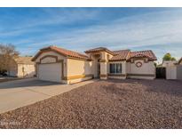 Single-story home with tile roof, attached garage, and desert landscaping at 2217 E Devon Ct, Gilbert, AZ 85296