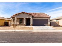 One-story house with brown roof and gray exterior, two-car garage, and desert landscaping at 2355 N Oakmont Ln, Casa Grande, AZ 85122