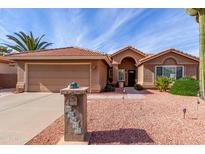 Tan house with tile roof, garage, and landscaped yard at 25432 S Queen Palm Dr, Sun Lakes, AZ 85248