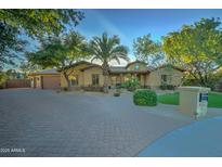 Beautiful one-story home with a large driveway and mature landscaping at 6502 N 81St Pl, Scottsdale, AZ 85250