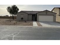 Single-story house with a two-car garage and landscaped front yard at 805 W Raymond St, Coolidge, AZ 85128