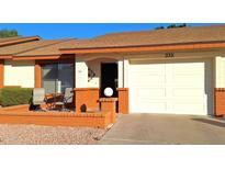 Ranch-style home with orange brick accents, a two-car garage, and a small patio at 8160 E Keats Ave # 335, Mesa, AZ 85209