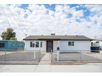 Newly renovated home with a fresh white exterior and a well-maintained front yard at 236 S 2Nd St, Avondale, AZ 85323