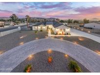 Stunning aerial view of a modern home with a circular driveway and beautifully landscaped yard at 2911 W Latona Rd # 1, Laveen, AZ 85339
