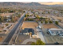 Aerial view showcasing a single-story home, expansive backyard, and surrounding neighborhood at 2911 W Latona Rd # 1, Laveen, AZ 85339