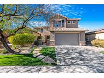 Two-story house with a gray exterior, landscaped yard, and a two-car garage at 40308 N High Noon Way, Phoenix, AZ 85086