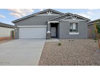Charming single-story home with a well-maintained front yard and a two-car garage at 46941 W Old Timer Rd, Maricopa, AZ 85139