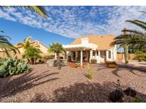 Spacious backyard oasis with a pergola, hot tub, and desert landscaping at 5965 E Teton Cir, Mesa, AZ 85215