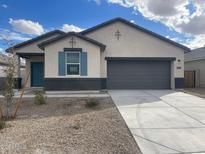 New single-story home with gray exterior and teal shutters at 641 W Freedom St, Florence, AZ 85132