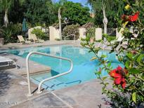 Inviting community pool with plenty of lounge chairs and lush landscaping at 9065 E Gary Rd # 124, Scottsdale, AZ 85260