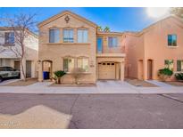 Tan two-story house with a garage and balcony at 1127 W Auburn St, Mesa, AZ 85201