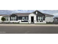 Stunning two-story home with a modern farmhouse design, landscaped yard, and welcoming front porch at 12058 N Loma Linda St, Surprise, AZ 85388