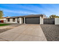 Newly remodeled home with a modern gray garage door at 1243 N Terripin --, Mesa, AZ 85207