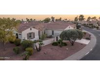 Wide shot of the community featuring desert landscaping, red rock, walkways and private patios at 12953 W Figueroa Dr, Sun City West, AZ 85375