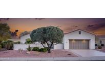 Charming single-story home featuring a desert landscape, front courtyard, and a two-car garage at 12953 W Figueroa Dr, Sun City West, AZ 85375