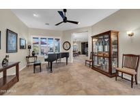Spacious living area featuring tile flooring, natural light, piano, and comfortable seating at 12953 W Figueroa Dr, Sun City West, AZ 85375