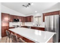 Modern kitchen with stainless steel appliances and an island at 1357 E Bradstock Way, San Tan Valley, AZ 85140