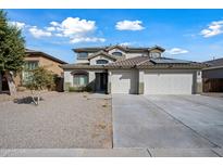 Two-story house with a three-car garage and desert landscaping at 14866 W Windsor Ave, Goodyear, AZ 85395