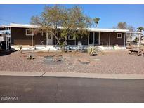 Mobile home with covered porch and desert landscaping at 156 N Hawes Rd # 75, Mesa, AZ 85207