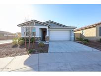 Single-story house with a two-car garage and desert landscaping at 19701 W Roma Ave, Litchfield Park, AZ 85340