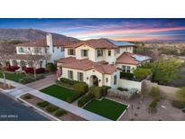 Two-story house with tile roof, solar panels, and landscaped yard at 20606 W Daniel Pl, Buckeye, AZ 85396