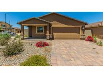 New single-story home with a two-car garage and landscaped front yard at 25838 W Samantha Way, Buckeye, AZ 85326