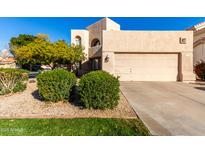 Tan two-story house with a two-car garage and nicely landscaped front yard at 3218 E Briarwood Ter, Phoenix, AZ 85048