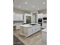 Spacious kitchen boasts white cabinets and a sizable island at 3957 E Expedition Way, Phoenix, AZ 85050