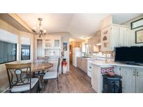 Bright kitchen features ample cabinetry and a dining area at 880 Motherlode Dr # 1099, Apache Junction, AZ 85119
