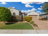 Single-story home with landscaped front yard, driveway, and two-car garage at 9438 W Weeping Willow Rd, Peoria, AZ 85383