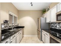 Modern kitchen with stainless steel appliances and granite countertops at 11260 N 92Nd St # 1102, Scottsdale, AZ 85260