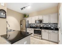 Modern kitchen with stainless steel appliances and granite countertops at 11260 N 92Nd St # 1102, Scottsdale, AZ 85260