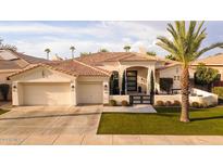 Stunning curb appeal! This home features a tile roof, two-car garage, and lush landscaping at 1710 W Glacier Way, Chandler, AZ 85248