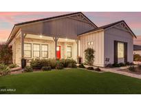 Charming single-Gathering home featuring a welcoming front porch, a red front door, and a well-manicured lawn at 25516 S 205Th Way, Queen Creek, AZ 85142