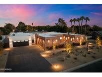 Stunning curb appeal! Brick house with landscaped yard, palm trees, and modern design at 3807 N 55Th Pl, Phoenix, AZ 85018