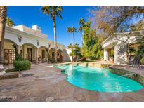 Inviting pool with stone patio, ideal for relaxation and entertaining at 6340 E Huntress Dr, Paradise Valley, AZ 85253
