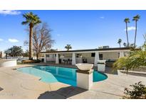 Inviting pool with spacious patio and palm trees at 6542 E Ludlow Dr, Scottsdale, AZ 85254
