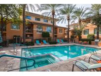 Inviting community pool with lounge chairs and BBQ area at 6940 E Cochise Rd # 1011, Paradise Valley, AZ 85253