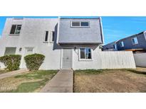 Cute 2 story stucco home with gray accents and a small front yard at 7509 N 47Th Dr, Glendale, AZ 85301