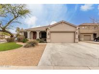 Charming single-story home featuring a two car garage and a well-maintained desert landscape at 7709 S 72Nd Dl, Laveen, AZ 85339