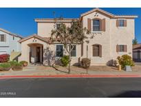 Two-story house with tan exterior, landscaped yard, and two-car garage at 832 E Stottler Dr, Gilbert, AZ 85296