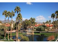 Community features lake, fountain, and Spanish-style homes at 9711 E Mountain View Rd # 1545, Scottsdale, AZ 85258