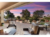 Relaxing patio with seating area, fire pit, and views of a golf course at 12920 W Figueroa Dr, Sun City West, AZ 85375