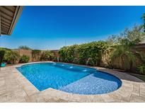 Inviting backyard pool with fountain feature at 14571 W Wethersfield Rd, Surprise, AZ 85379