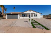 Updated single-story home with gray garage door and landscaped walkway at 2019 N 56Th Dr, Phoenix, AZ 85035