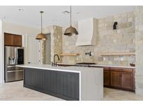 Modern kitchen with stainless steel appliances and a large island at 22761 E Poco Calle St, Queen Creek, AZ 85142