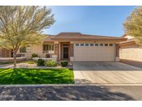 Single-story home with a two-car garage and landscaped front yard at 2663 S Springwood Blvd # 311, Mesa, AZ 85209
