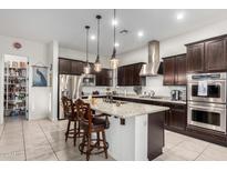 Kitchen with an island, granite countertops, and stainless steel appliances at 3222 S 186Th Ln, Goodyear, AZ 85338