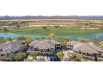 Aerial view of a community with lake, golf course, and residential buildings at 33550 N Dove Lakes Dr # 2023, Cave Creek, AZ 85331