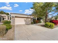 Attached two-car garage with stone exterior at 3830 E Carter Dr, Phoenix, AZ 85042